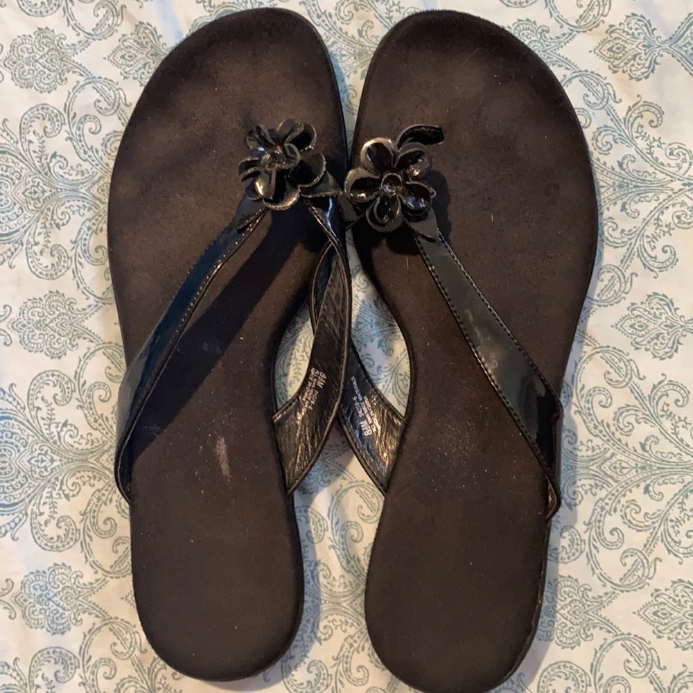 Gently used patented black flower flip flops